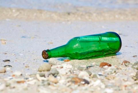 Bottle with message on the beach Stock Photos