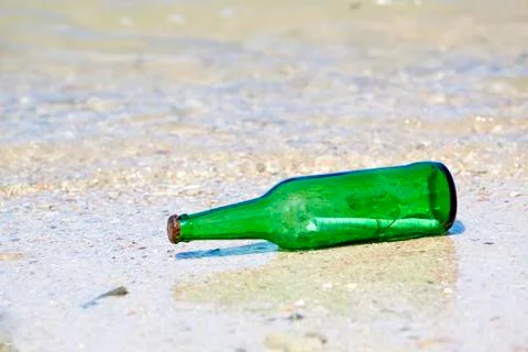 Bottle with message on the beach Stock Photos
