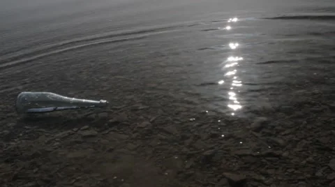 Bottle with a message floating in the water Stock Footage 61146469