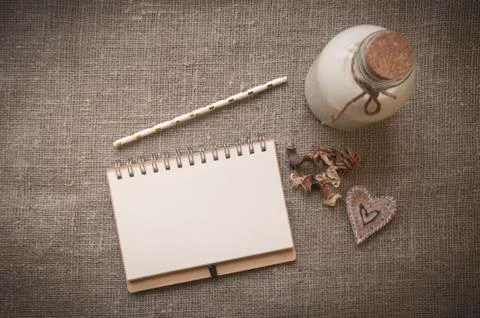 Bottle of milk and notebook on background of linen Stock Photos