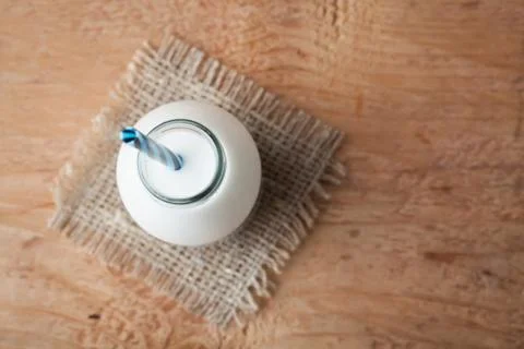 Bottle with milk on dark background with copy space. Top view Stock Photos