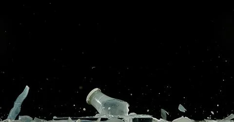 Bottle of Milk Exploding against Black Background 写真素材