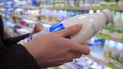 A bottle of milk in the hands of a customer Video stock 300278414