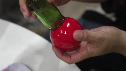Bottle Neck Polishing a Mirror Bright Red Clay Ball Stock Footage 340901162