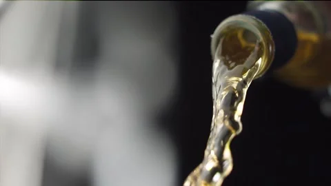 Bottle neck while pouring whiskey liquid in slow motion Stock Footage 145848817