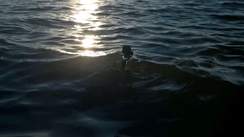 A bottle with a note swings on the waves Stock Footage 77723082