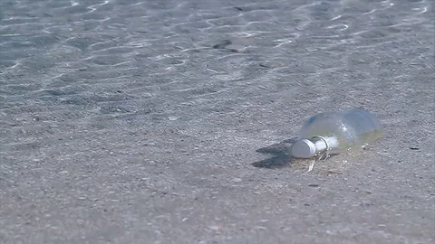 Bottle with old paper message inside in the ocean Stock Footage 71901327