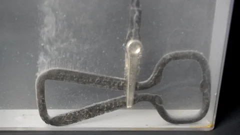 Bottle opener streams hydrogen bubbles during electroplating. Stock Footage 320466098
