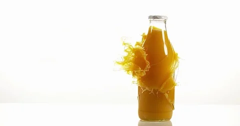 Bottle of Orange Exploding against White Background, Slow Motion 4K 動画素材 75977073