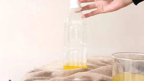 A bottle of orange juice on a table Stock Footage 146251506