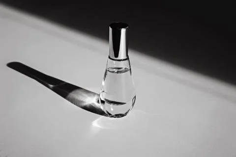 Bottle of perfume with contrast shadow 스톡 사진
