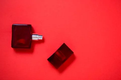 Bottle of perfume on red background Stock Photos