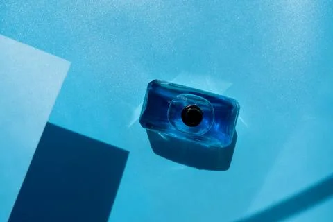 A bottle of perfume stands on the surface Stock Photos
