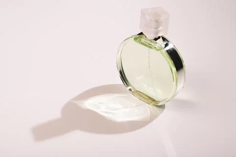 A bottle of perfume on a white background with a shadow Stock Photos