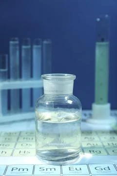 Bottle on periodic table of chemical elements Stock Photos