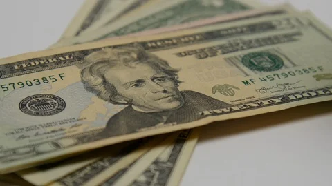 Bottle of pills pours out onto stack of money. Stock Footage 108070436