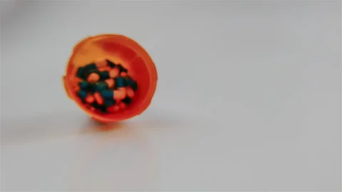 Bottle of pills spilling in slow motion; Covid-19 theme 動画素材 132670540