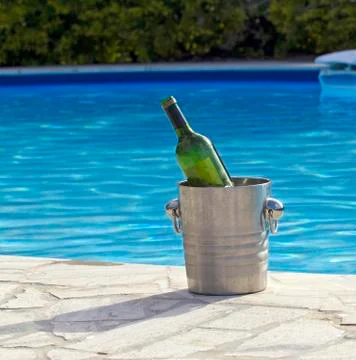 Bottle by the pool Stock Photos