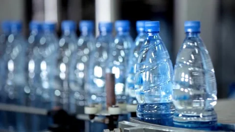 Bottle with pure Clean water in plastic bottle moves through conveyor factory. Stock Footage 334587753