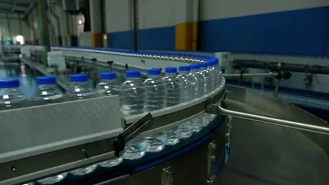 Bottle with pure Clean water in plastic bottle moves through conveyor factory. Stock Footage 334587755