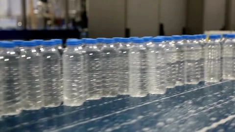 Bottle with pure Clean water in plastic bottle moves through conveyor factory. Stock Footage 334587783