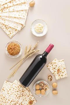 Bottle of red kosher wine, matzoth bread, walnuts, fruit mix on beige Stock Photos