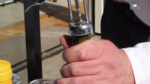 A bottle of red wine being opened at a summer party Stock Footage 80436005