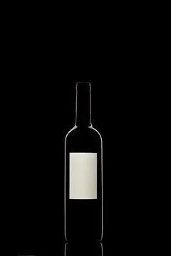 Bottle of red wine on a black background Stock Photos