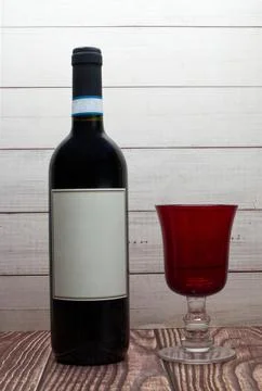 Bottle of red wine with blank label and red glass Stock Photos