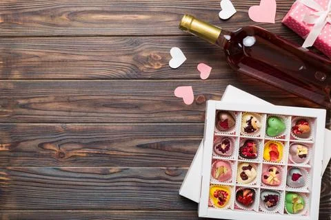 Bottle of red wine on colored background for Valentine Day with gift and ch.. Stock Photos