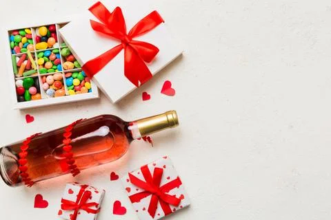 Bottle of red wine on colored background for Valentine Day with gift and ch.. Stock Photos