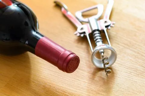 Bottle of red wine with a corkscrew Stock Photos
