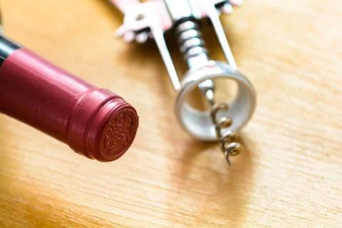 Bottle of red wine with a corkscrew Stock Photos