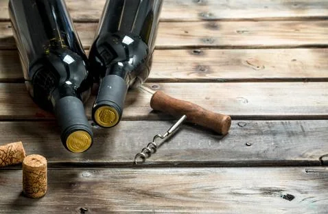 Bottle of red wine with a corkscrew. Stock Photos