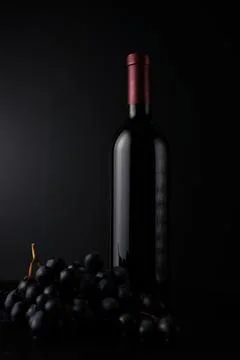 Bottle of red wine on dark background. Stock Photos