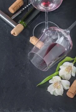 Bottle of red wine, glass, corks and corkscrew Stock Photos