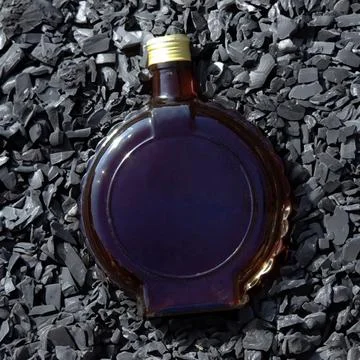 Bottle on the rocks Stock Photos