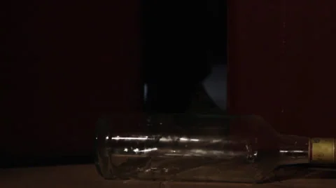 Bottle rolling on the floor, close up shot Video stock 34404834