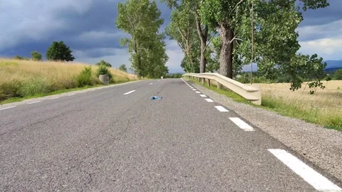 A bottle rolls seemingly up the hill, antigravitional hill Video stock 246878707