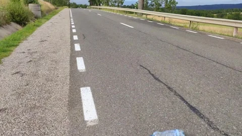 A bottle rolls seemingly up the hill, antigravitional hill Stock Footage 246878751