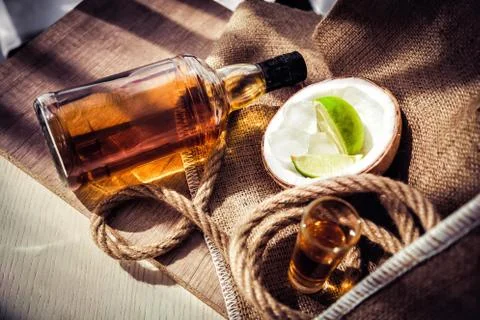 Bottle of rum with lime ice and coconut, coconut glasses and rum Stock Photos