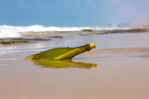 Bottle on the shore . Stock Photos