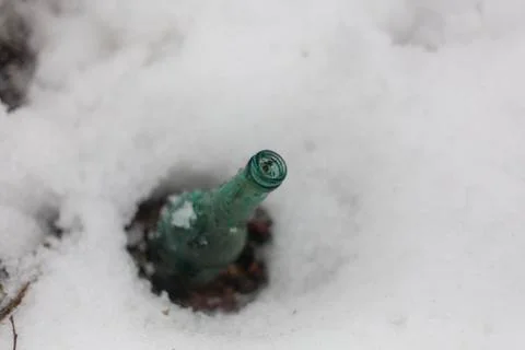 Bottle in the snow Stock Photos