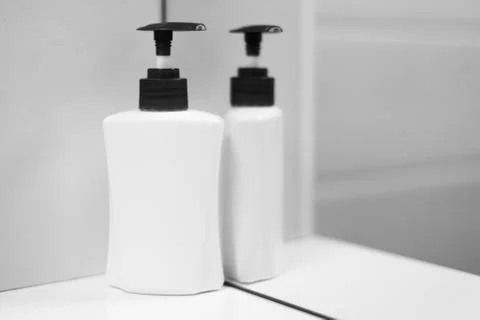 A bottle of soap with reflection in mirror. Stock Photos