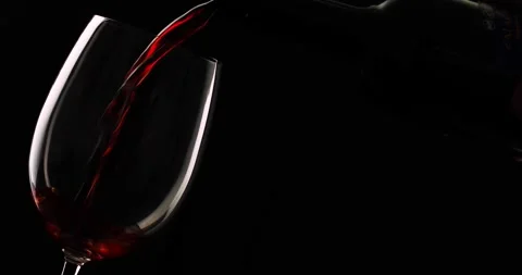 Bottle splash serving wine in glass Stock Footage 136064805