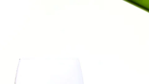 Bottle splash serving wine in glass Stock Footage 136064825