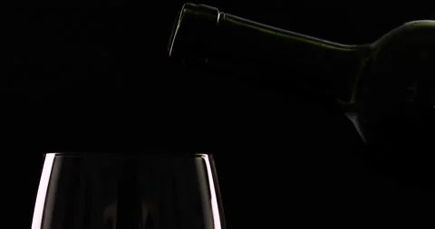 Bottle splash serving wine in glass 4k Stock Footage 136065180