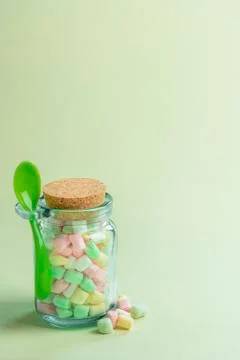 Bottle with spoon full of mini marshmallows Stock Photos