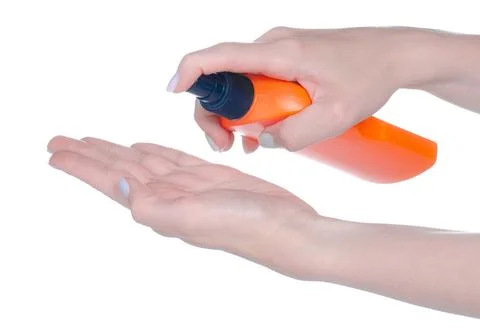Bottle sunscreen spray in hand Stock Photos