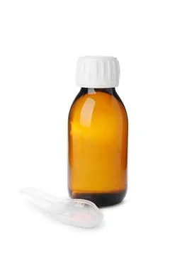 Bottle of syrup with plastic spoon on white background. Cough and cold medici Stock Photos